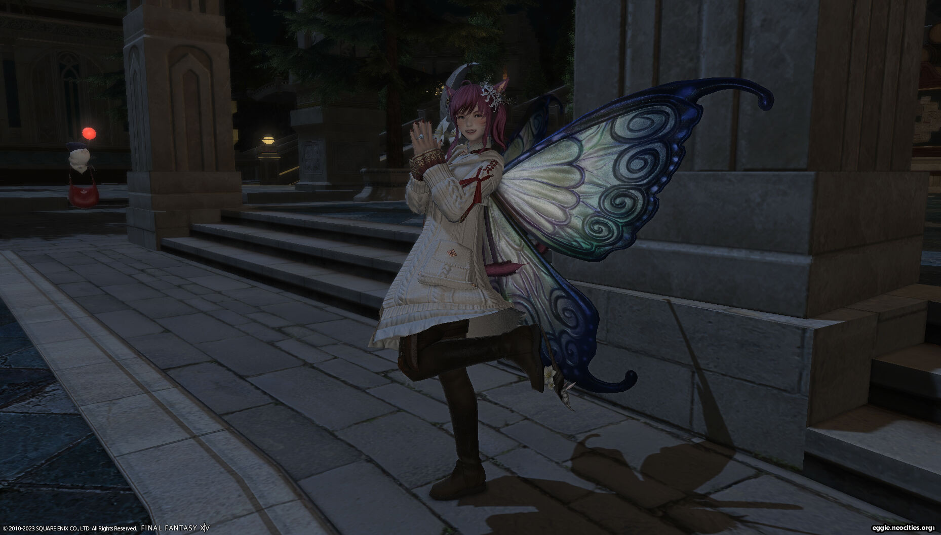 Zel with Statice Wings, a pair of silvery butterfly wings with blue and green at the borders. She is performing the Joy emote.