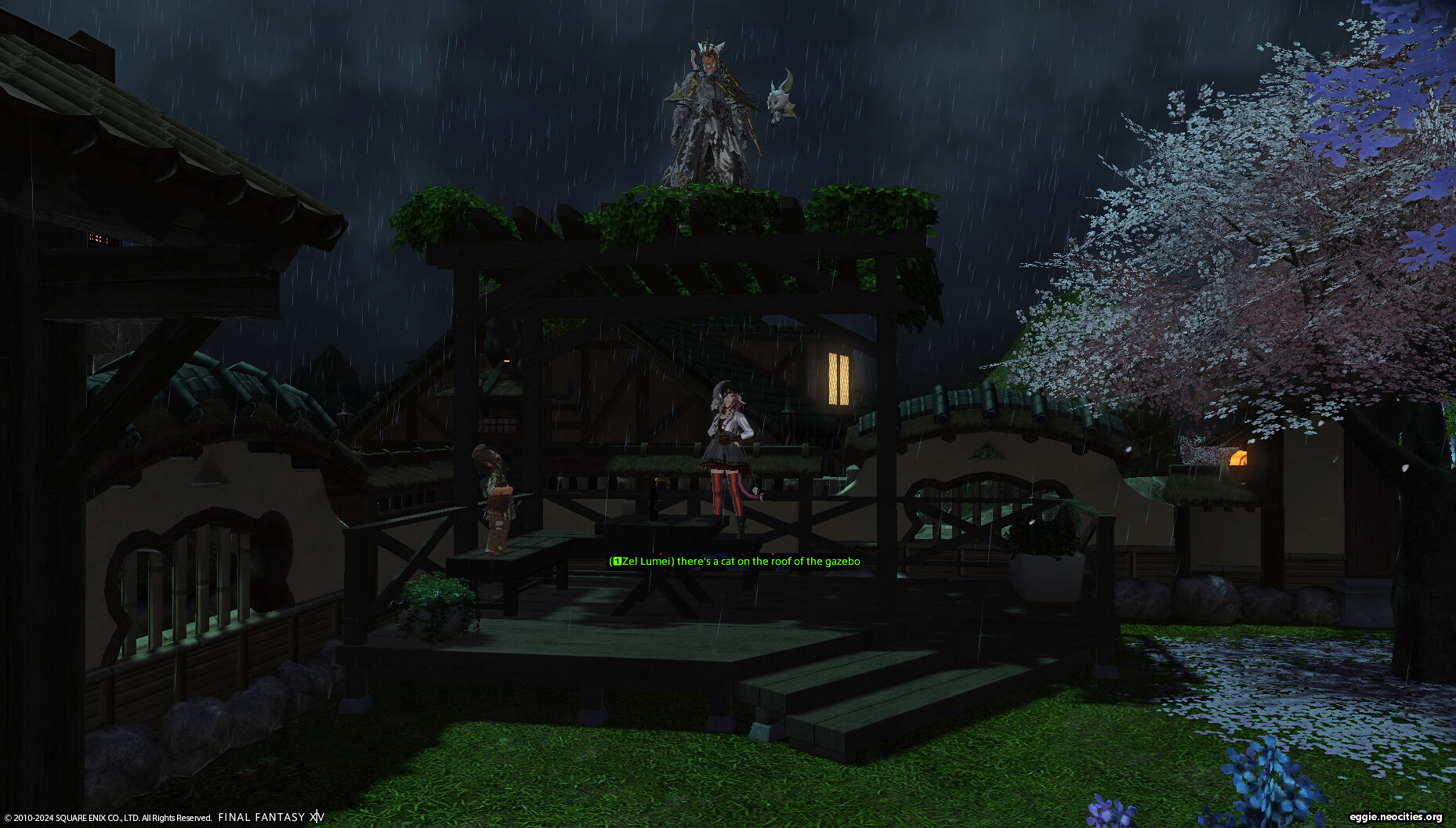 Zel and Mucho standing in a Gazebo, looking up at Mag who is on the roof. There is a chatbox overlaid of text from Zel: There's a cat on the roof of the gazebo