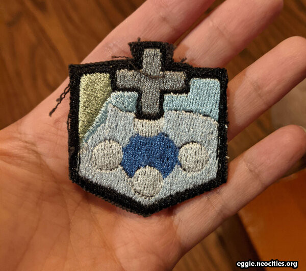 A machine embroidered patch depicting the FFXIV status effect Freecure