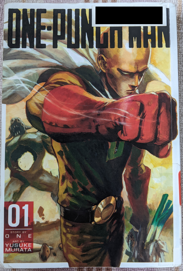 Cover for Volume One of One Punch Man, written by One, Art by Murata Yusuke. Artwork shows Saitama in his hero outfit, a yellow jumpsuit with red gloves, a belt with a large round buckle, and a white cape, in the foreground, carrying a plastic bag of groceries with a leek sticking out. His fist is raised chest high as if he has just finished punching something, with motion lines coming off his fist. His expression seems angry. In the background is a bipedal blue-green monster with four eyes and two horns. It has a large hole in its torso.