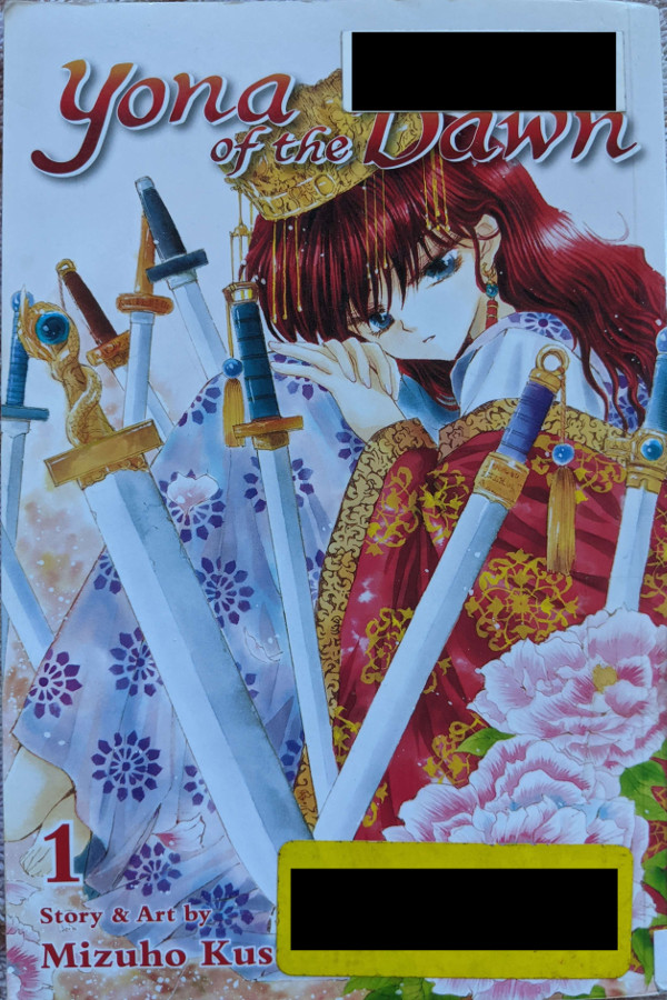 Cover for Yona of the Dawn Volume 1. Yona, a princess with long, wavy red hair, sits almost crouching, with her knees to her chest. She is surrounded by seven swords, and there are two pink camellia flowers in the foreground.