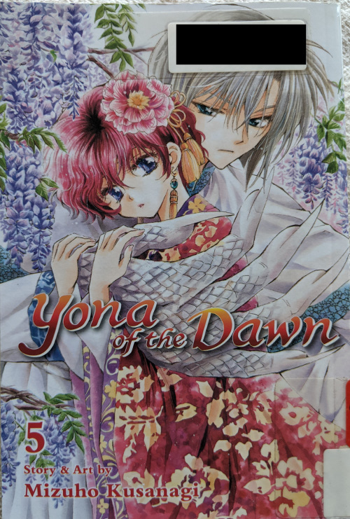 Cover for Yona of the Dawn Volume 5. Yona is dressed in red robes, with a red camellia in her hair. Behind her is Gija, holding her with his white dragon arm. There are purple wisteria in the background.
