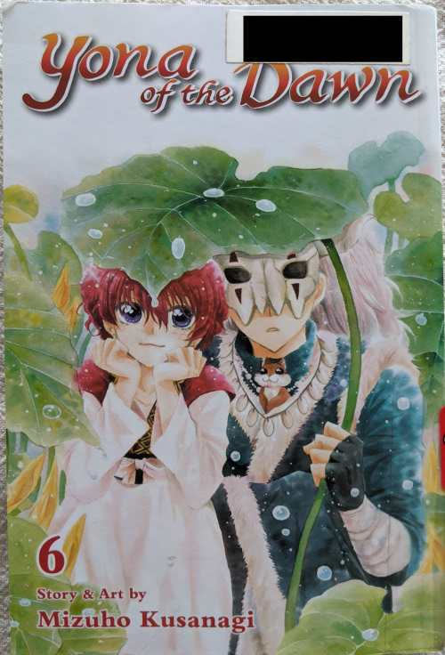 Cover for Yona of the Dawn Volume 6. Sinha and Yona are surrounded by taro leaves. Sinha is holding a large taro leaf over Yona's head, and Aoi the chipmunk sits in his shirt collar.