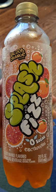 A bottle of Blood Orange flavored Splashfizz. The lettering is designed after North American grafitti, with lots of small white bubbles all over. There are also several whole oranges and sliced oranges. At the bottom it reads 0 Sugar, with little wings on the 0.