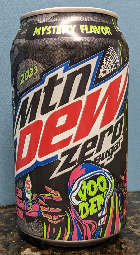 A can of Mountain Dew Zero Sugar Halloween 2023 VooDew Mystery Flavor. Can is dark gray, and has a grim reaper like figure at the bottom in pink robes, holding a candle with a number 5 in the flames.