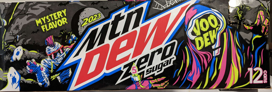 Box of Mountain Dew Zero Sugar Halloween 2023 VooDew Mystery Flavor. The box art depics a spooky, gray toned background with ghosts and bats. The moon has 2023 overlayed on it. On the left are two spooky ghosts, as well as one grinning mummy with pink sunglasses, a hot pink mohawk, and pink finger tips. On the right is a cloaked figure with colorful neon robes. In the opening to the hood there is no face, just the words Voo Dew. He is holding a candle in a bony hand, in the flame is the number 5. Behind him too his right is a jester's head on a stick.